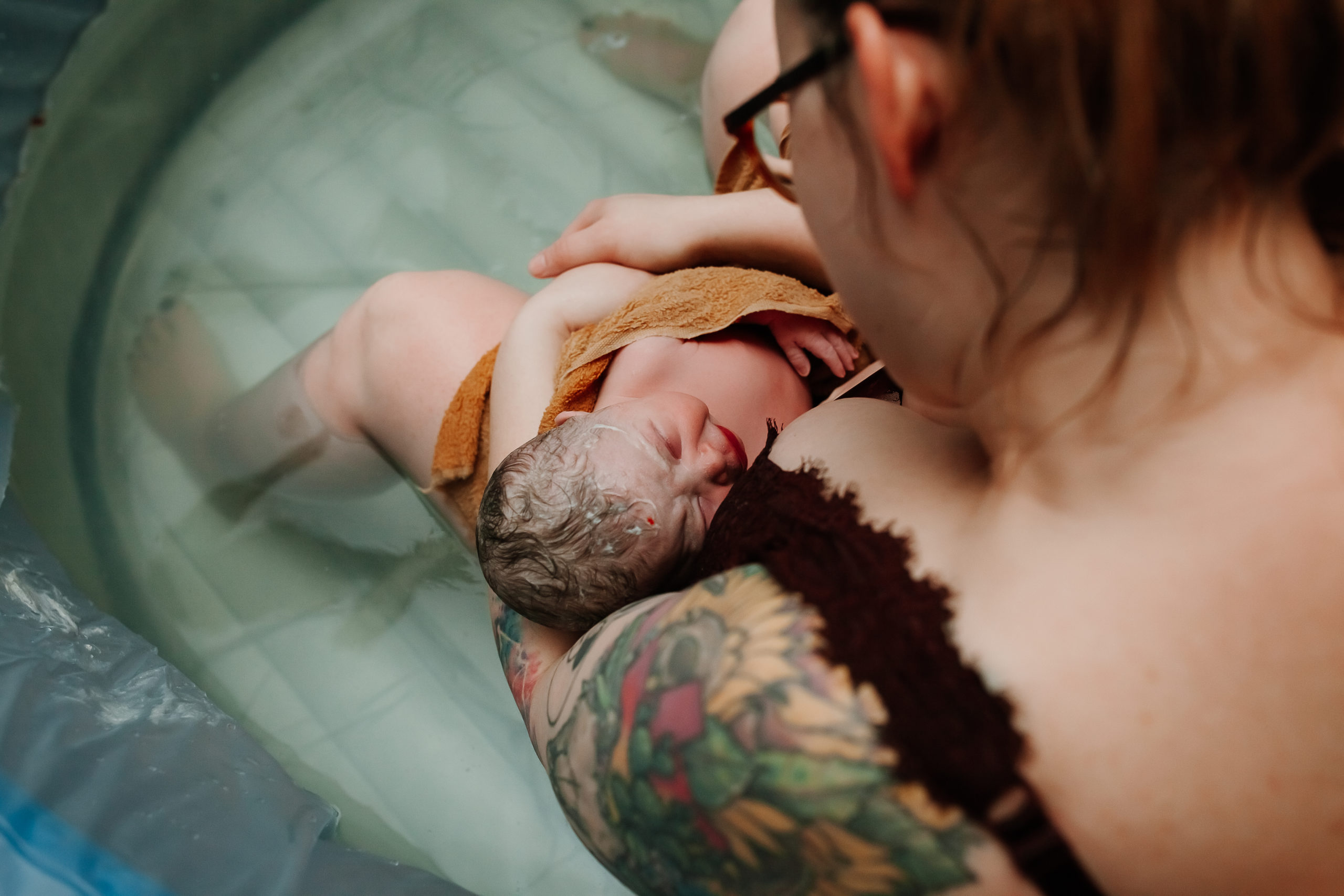 mom and newborn in birth pool