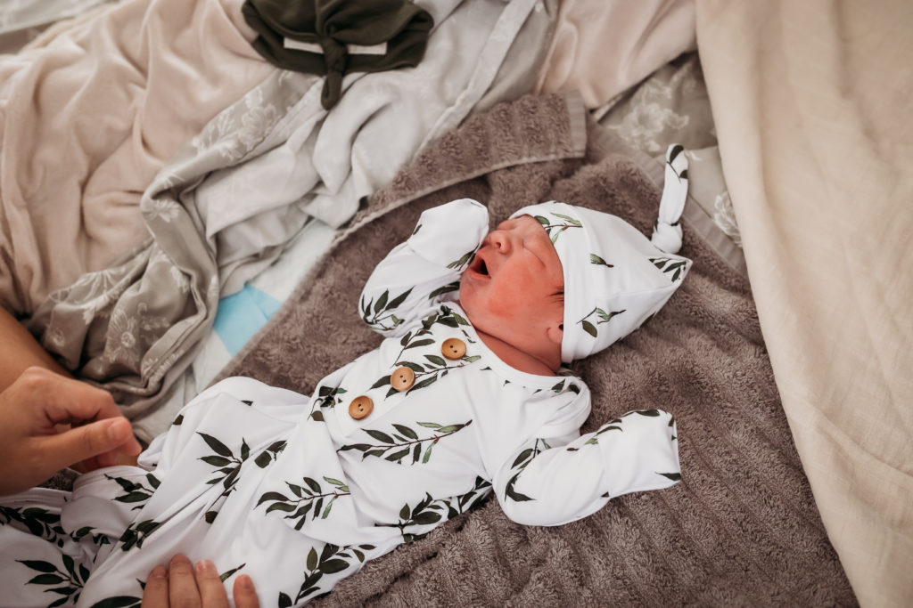 newborn in swaddle outfit